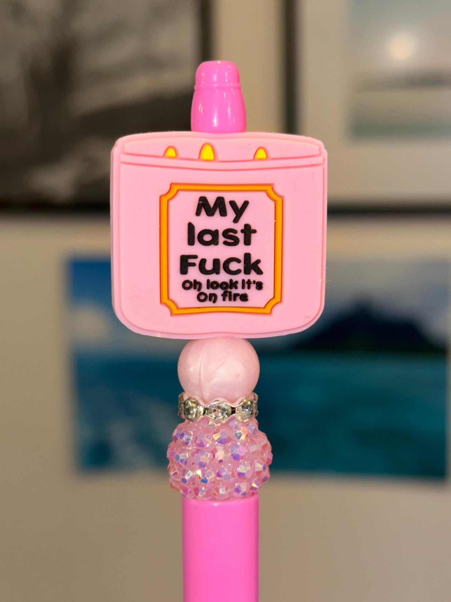 Pink pen with silicone and acrylic beads, rhinestones, and refillable black ink on fire design