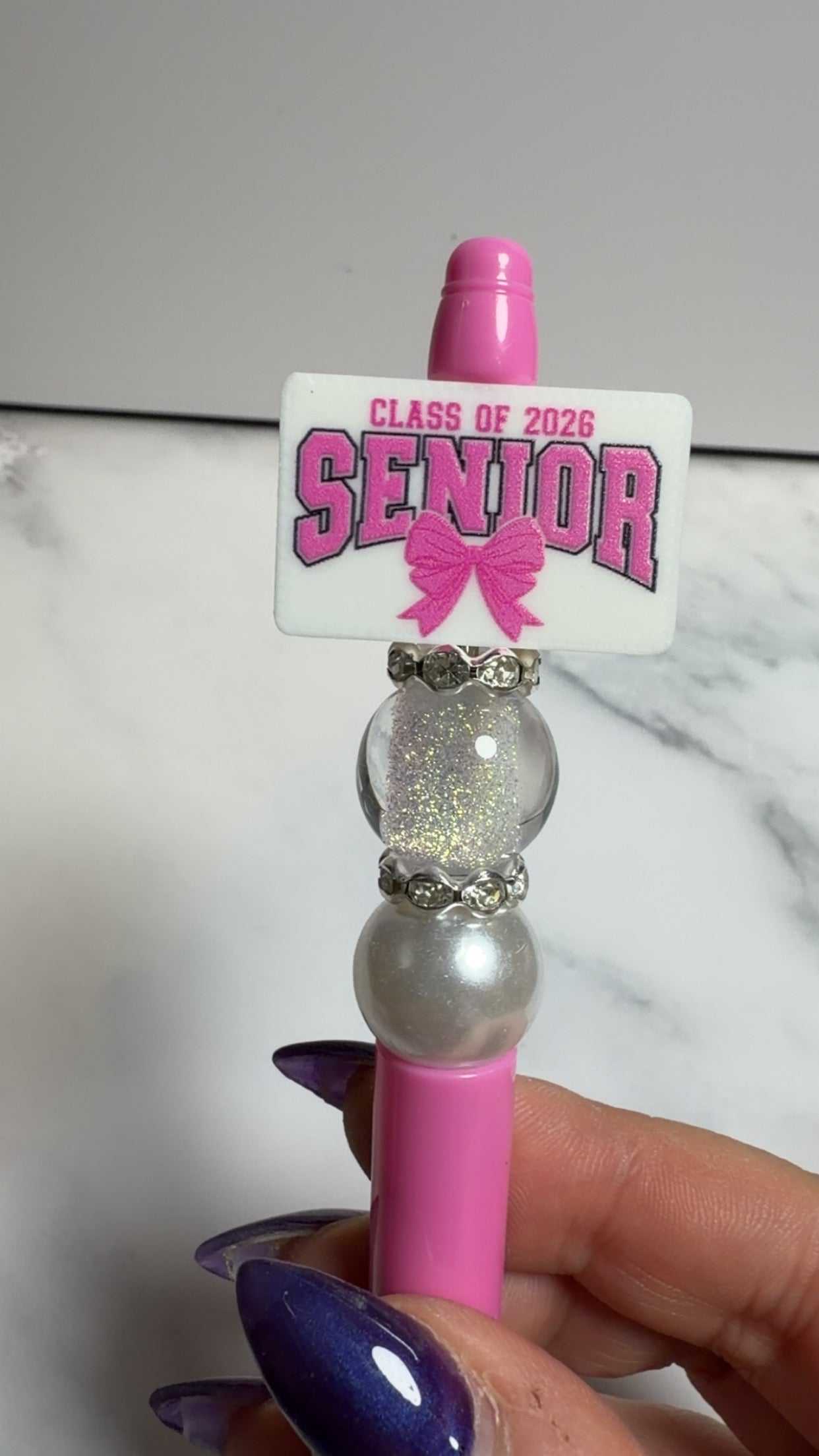 Senior Class of 2026 pen decorated with silicone and acrylic beads, rhinestones, and black ink
