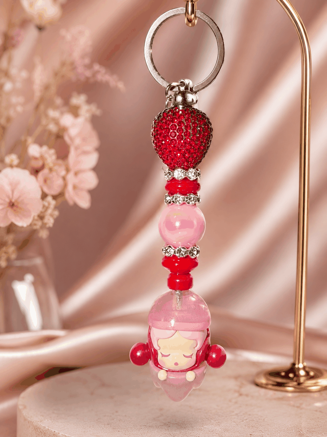 Pink and red authentic Skullpanda Soda Pop bean bag charm keychain featuring decorative beads, rhinestone spacers, and a sparkling red crystal bead hanging from a silver keyring.