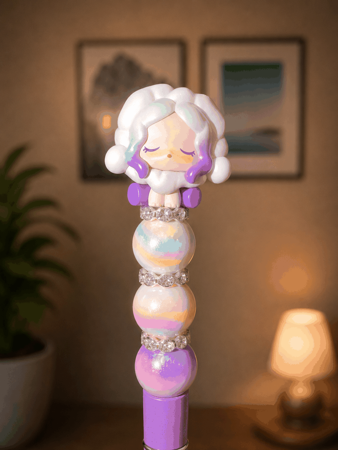 Handmade beaded pen featuring an authentic Skullpanda Pop Bean collectible topper with lavender accents, pastel rainbow iridescent beads, sparkling rhinestone spacers, and a coordinating lavender pen base