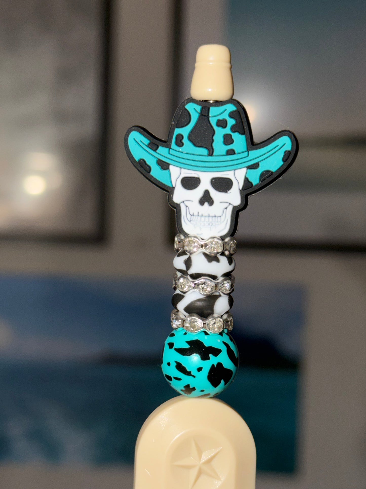 Cowboy skull beaded box cutter with teal cow print and rhinestones on cream retractable opener