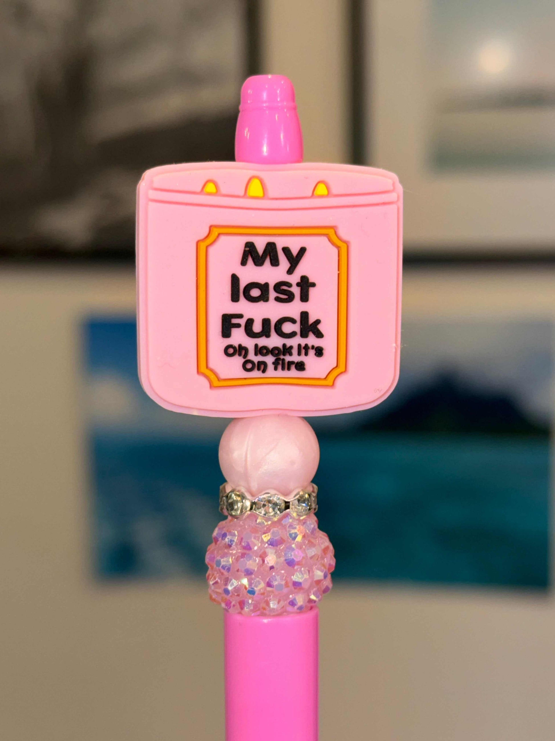 Pink pen with silicone and acrylic beads, rhinestones, and refillable black ink on fire design