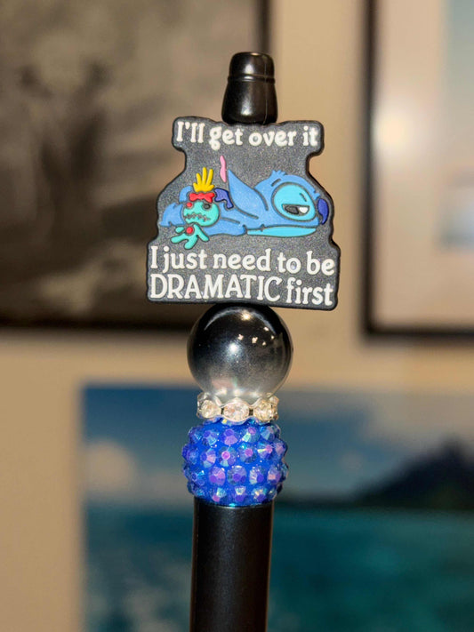Beaded black pen with dramatic quote charm, black shimmer bead, blue-purple pavé bead, and rhinestone spacer.