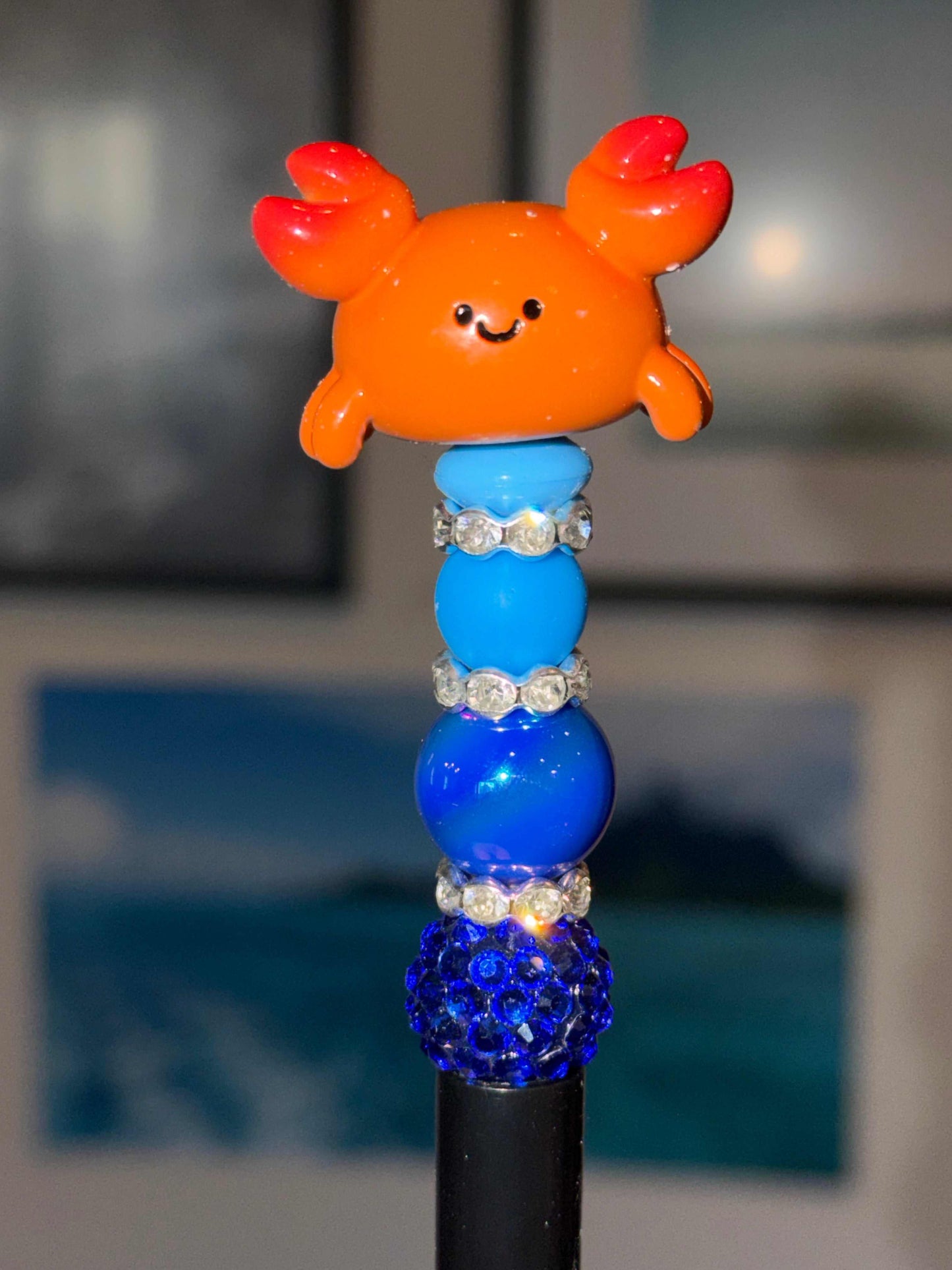Kawaii crab beaded pen with Meichai bean topper and ocean blue rhinestones on black barrel