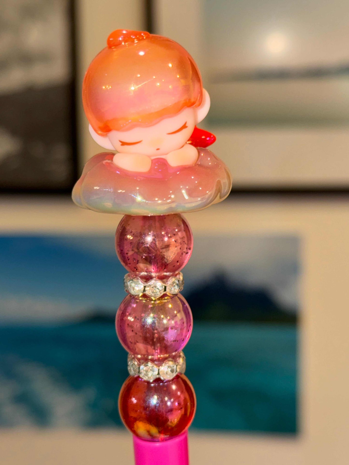 Sleeping angel girl pen topper on pink iridescent cloud with rhinestone accents