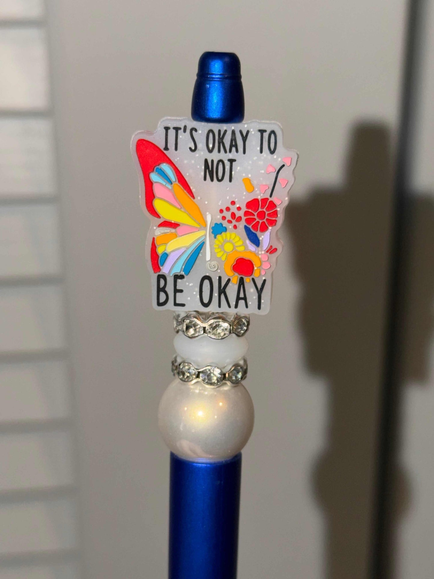 Blue pen with silicone and acrylic beads, rhinestones, and refillable black ink