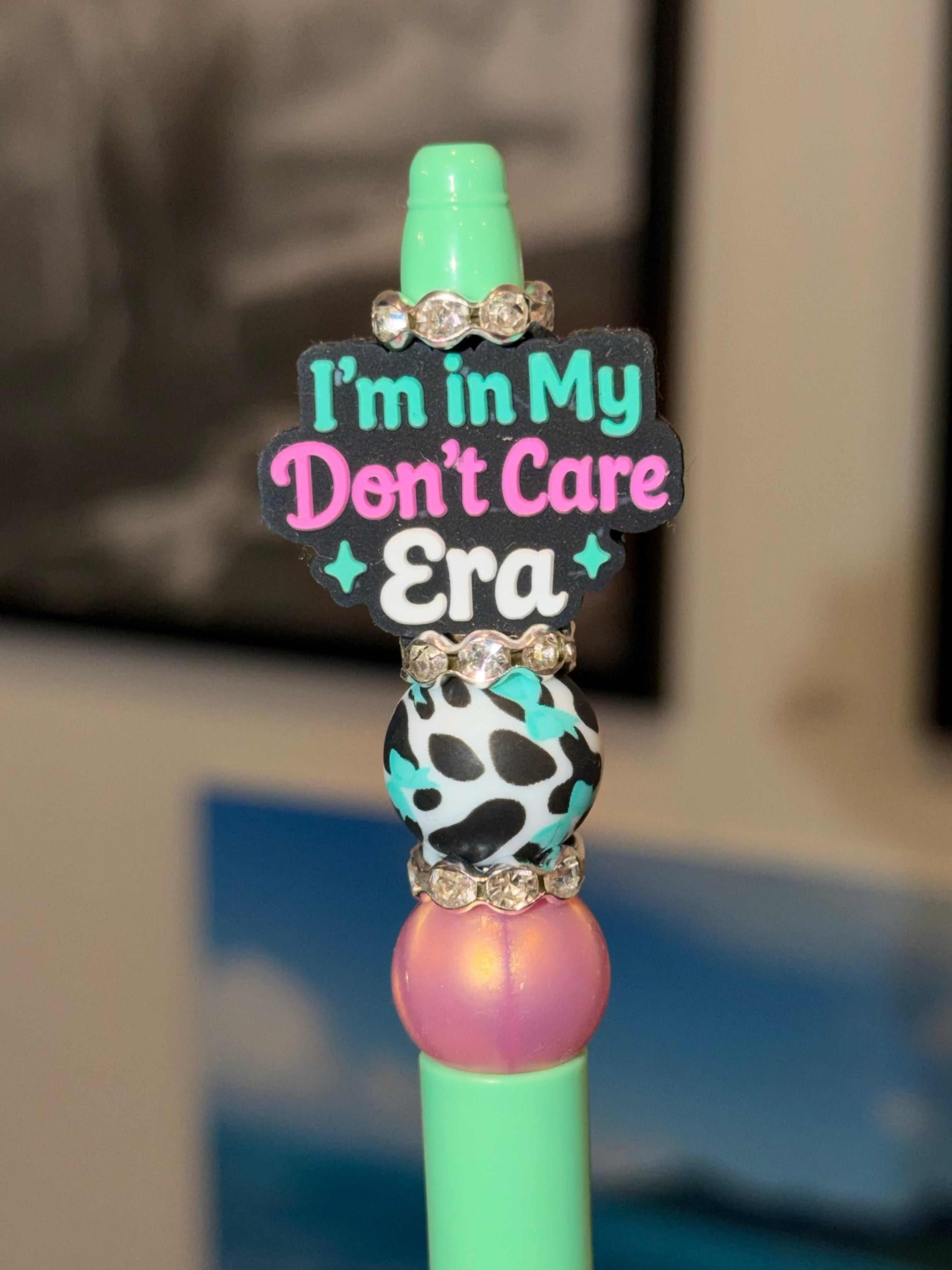 Teal pen with silicone beads and rhinestones featuring "I’m In My Don’t Care Era" design