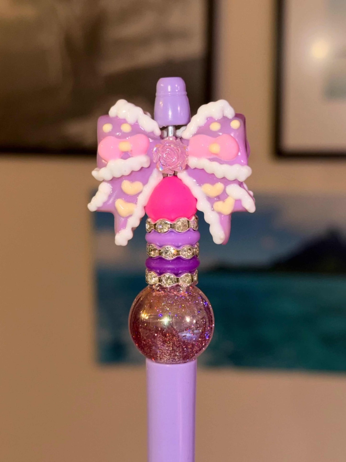 Purple and pink bow on a purple refillable pen with silicone beads and rhinestones