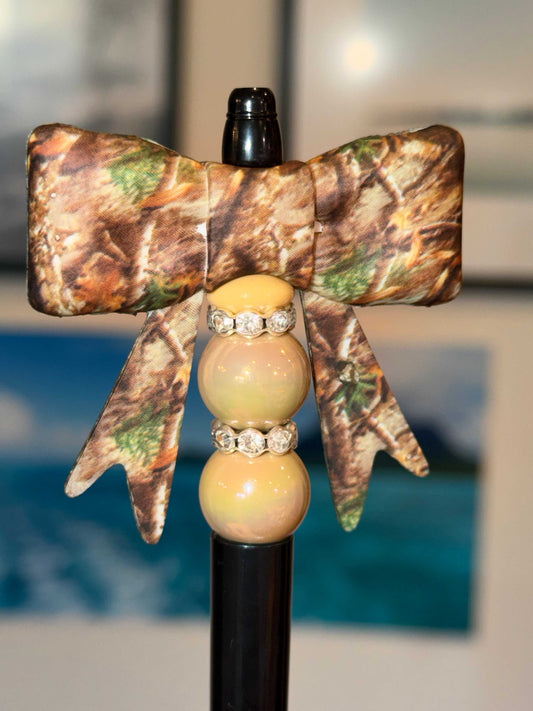Handmade camo bow beaded pen with woodland camo fabric bow, tan and nude beads, and rhinestone spacers