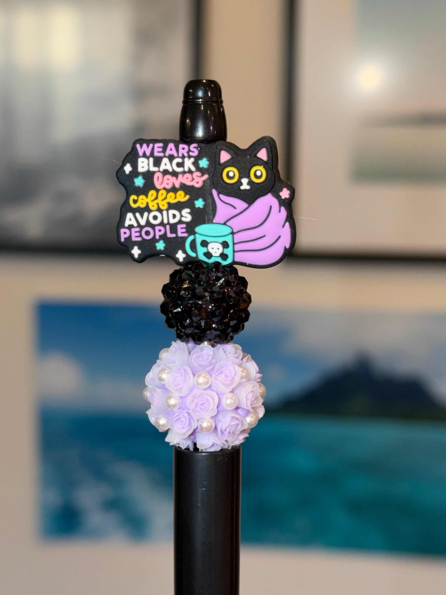 Handmade beaded pen with "Wears Black Loves Coffee Avoids People" black cat charm, black pave bead, and lavender rose pearl bead on black barrel