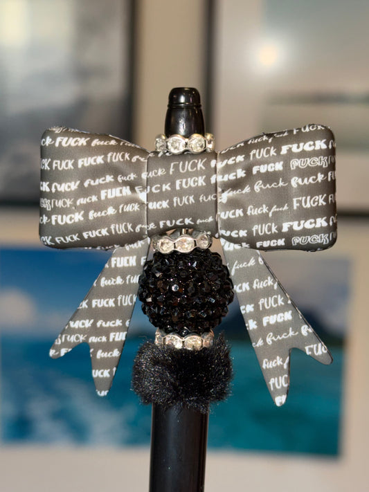 Handmade F*** Bow Beaded Pen with gray profanity print bow, black pave rhinestone bead, and black pom pom on black pen barrel