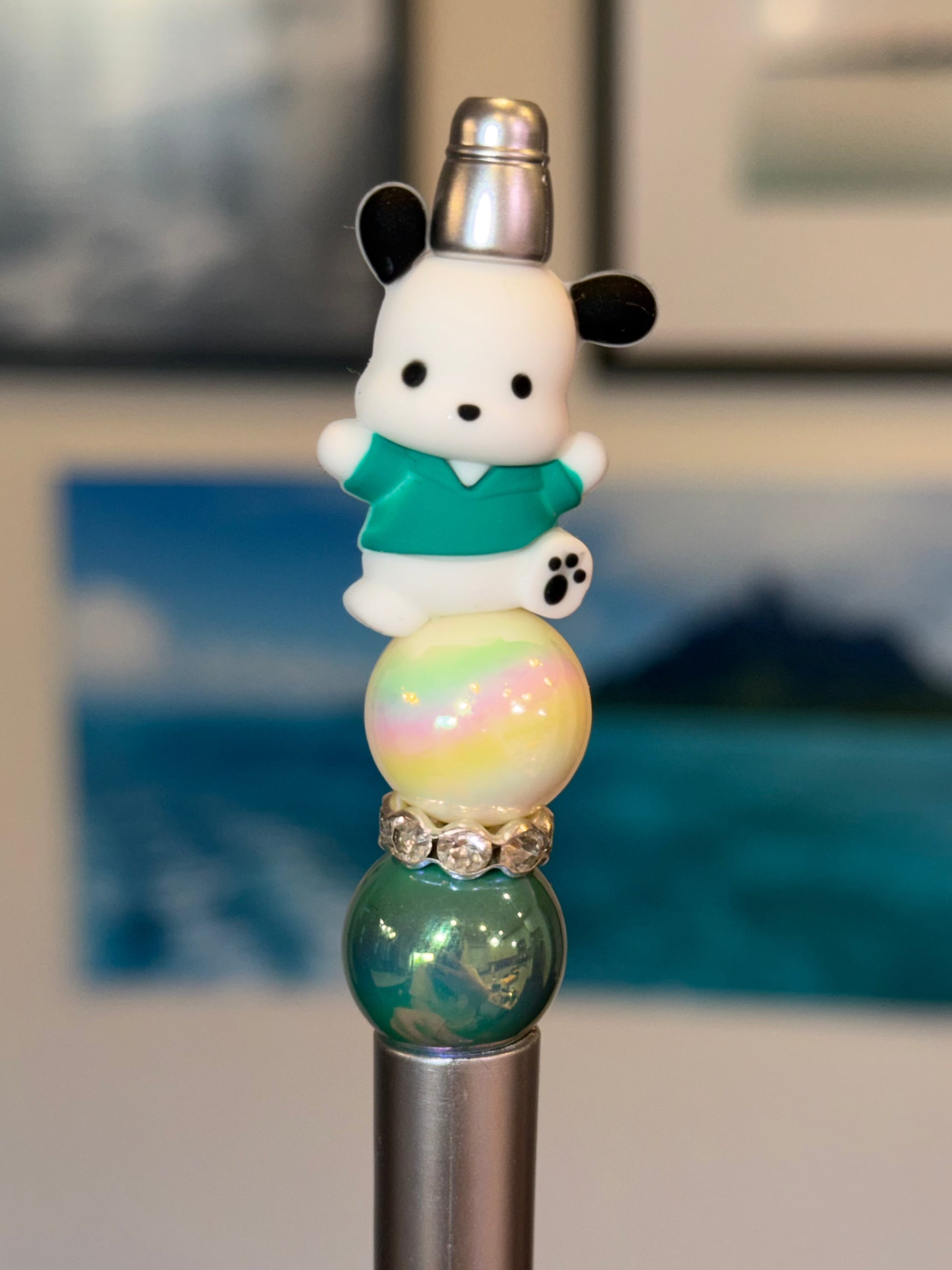 Handmade Pochacco inspired Sanrio beaded pen with iridescent bubble bead and teal accents on silver barrel