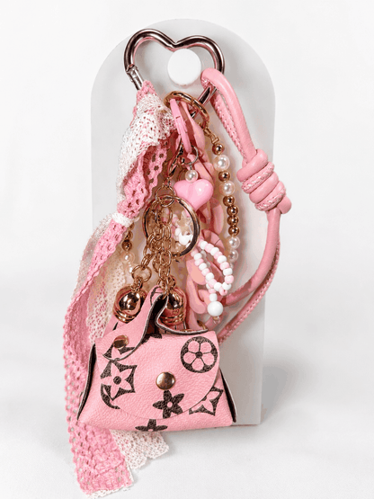 Coquette pink bag charm keychain with mini purse, pearls, lace bow, and chunky pink chain links