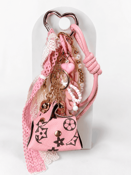 Coquette pink bag charm keychain with mini purse, pearls, lace bow, and chunky pink chain links