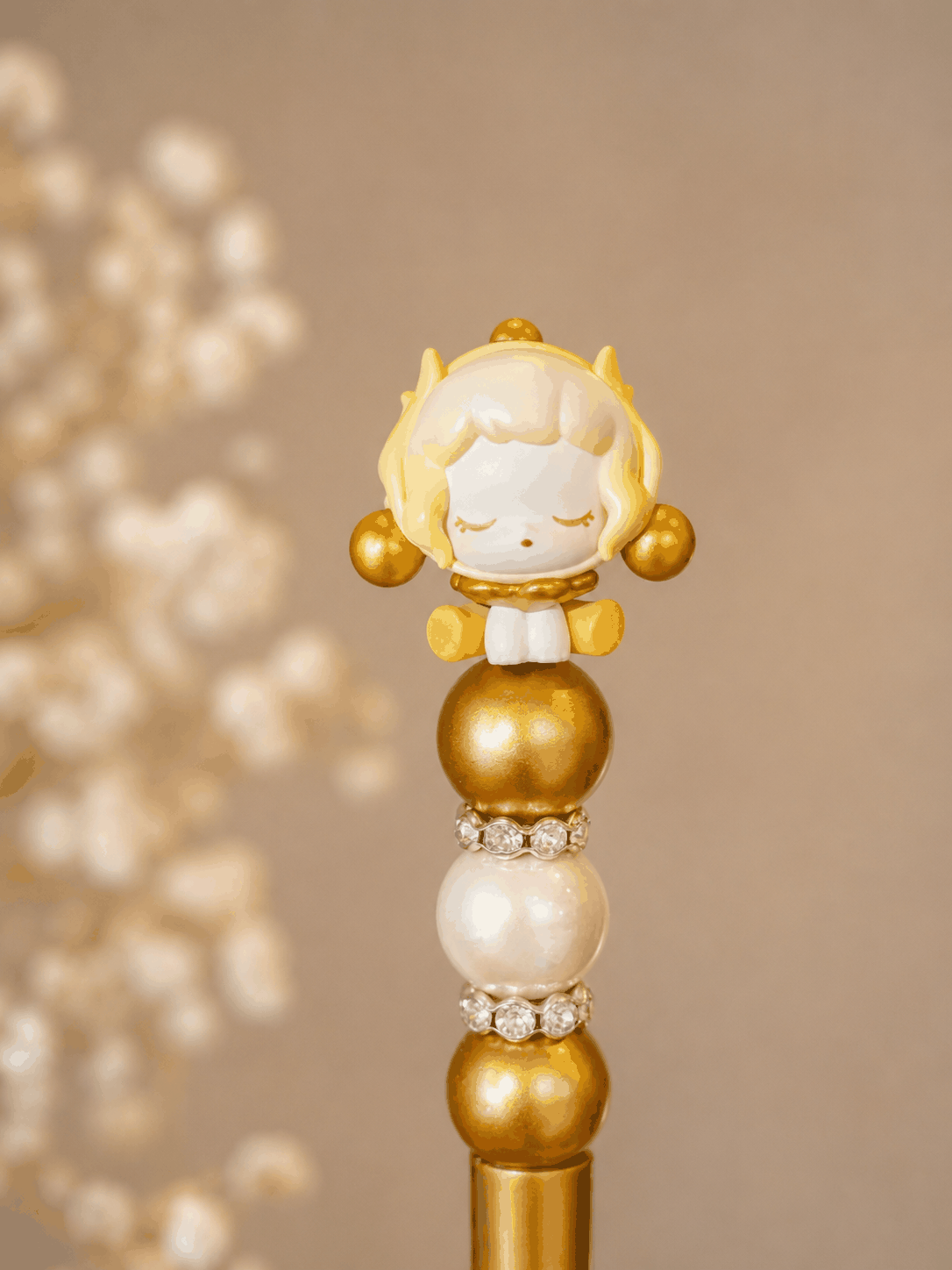 Handcrafted golden skull panda pen with floral topper, gold beads, pearls, and rhinestones