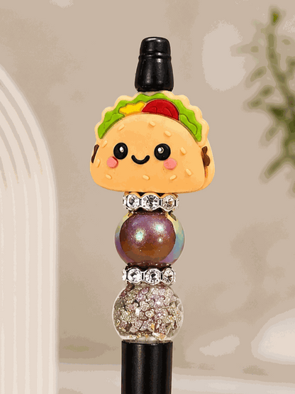 Handmade kawaii taco black pen with smiling taco bead, glitter-filled and rhinestone accent beads
