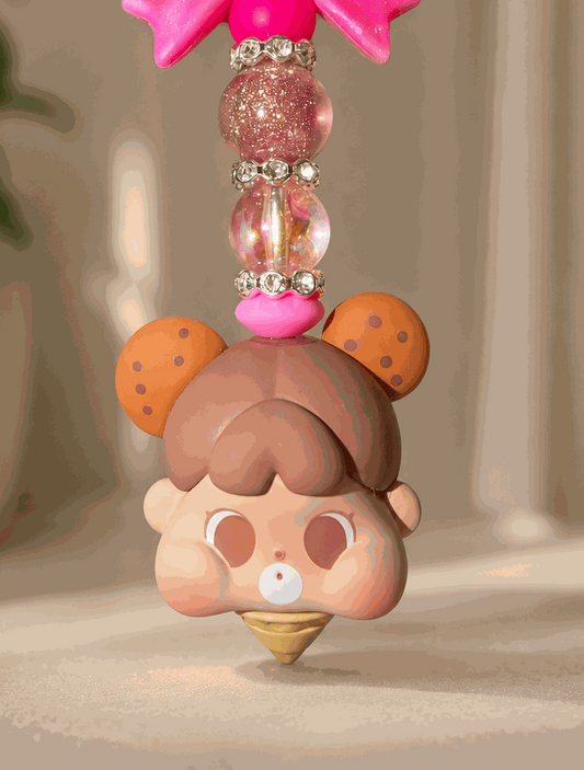 Handmade kawaii bag charm featuring a cute ice cream baby character, glitter pink bow, iridescent beads, and rhinestone spacers displayed against a soft neutral background.