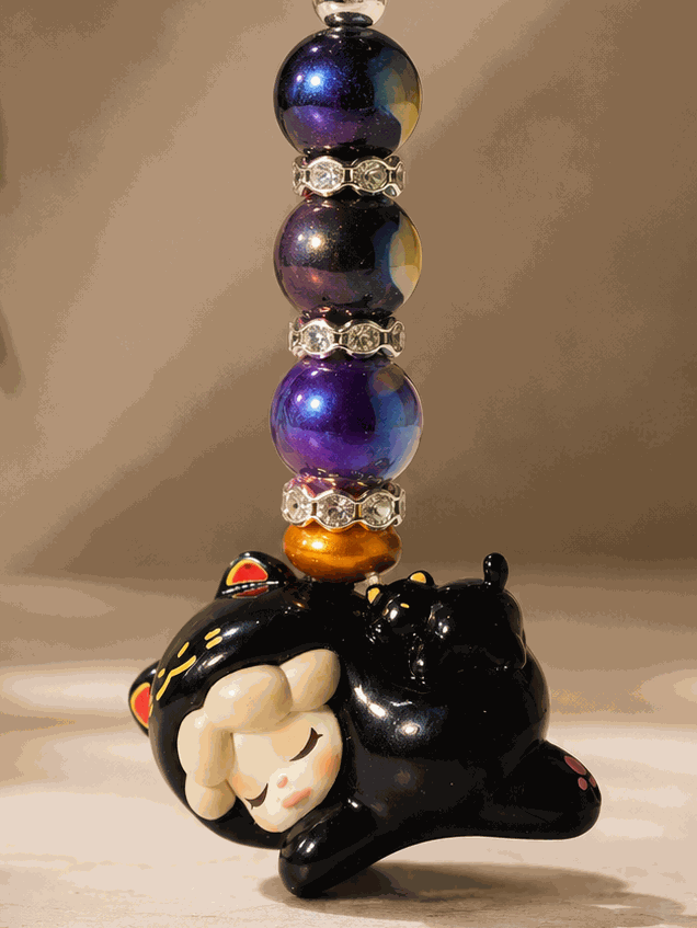 
Authentic Wendy bean bag charm keychain featuring a sleeping Wendy character charm, purple galaxy-inspired beads, rhinestone spacers, bronze accents, and a silver keyring displayed on a professional neutral background.