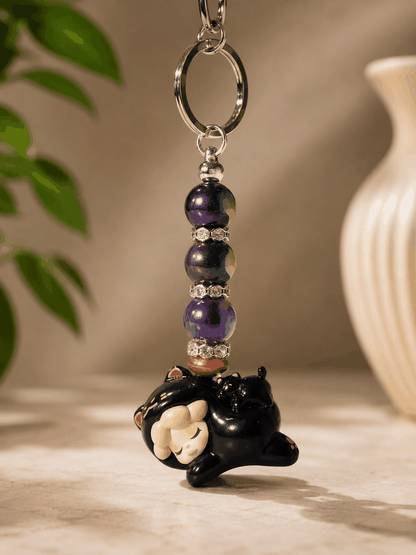 Authentic Wendy bean bag charm keychain featuring a sleeping Wendy character charm, purple galaxy-inspired beads, rhinestone spacers, bronze accents, and a silver keyring displayed on a professional neutral background.