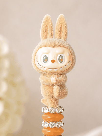 Labubu Golden Hour Pen with sandy beige bunny figure, teal diamond eyes, and gold bead stack luxury desk accessory