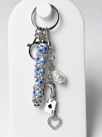 Blue and white porcelain inspired beaded bag charm keychain with horseshoe, Ace of Spades, rhinestones, and freshwater pearl