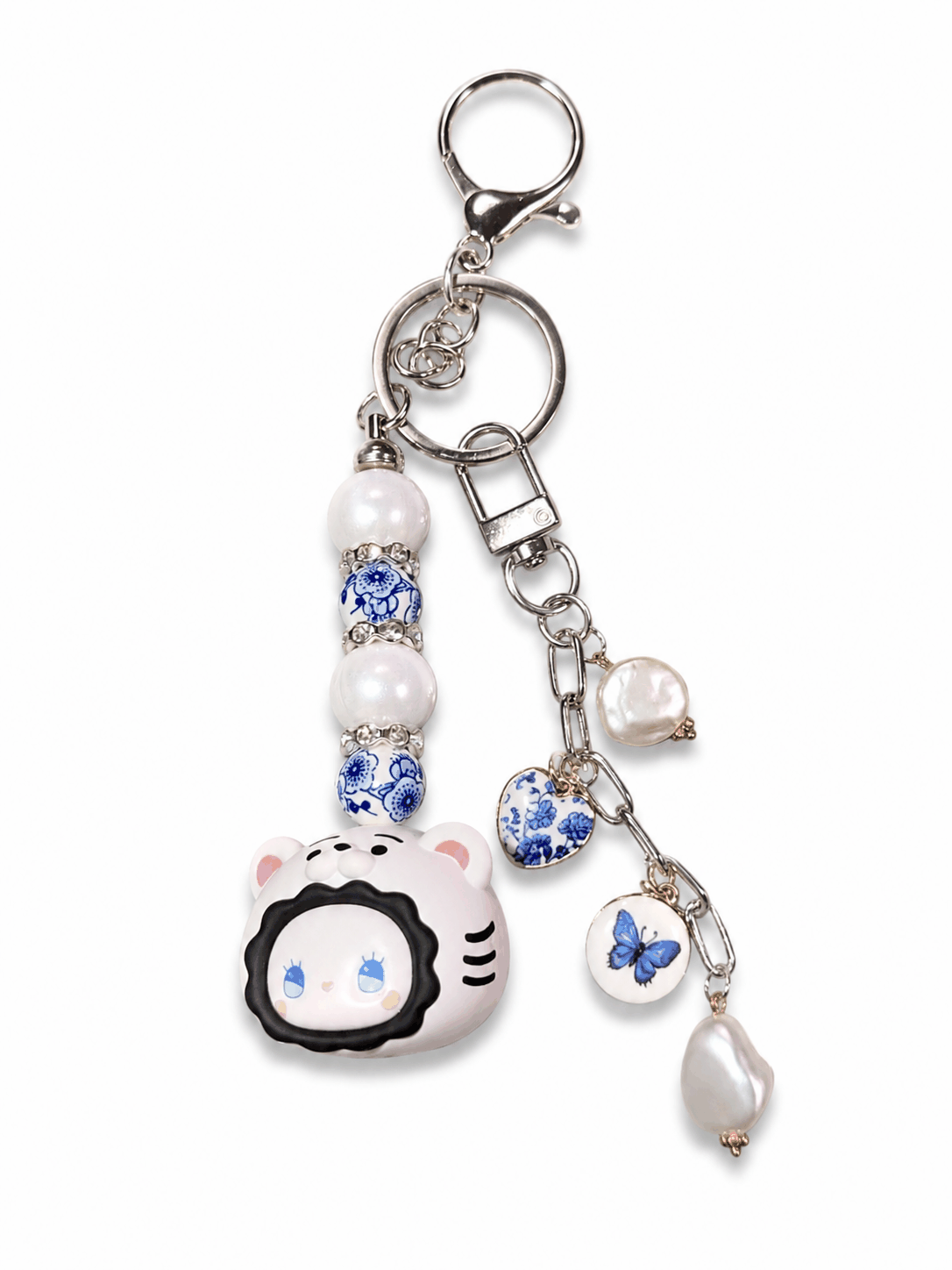 Authentic Emma Bean bag charm keychain with freshwater pearls, blue porcelain-inspired beads, butterfly charm, heart charm, and silver lobster clasp on a white background.
