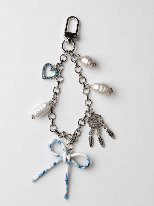 Blue Bow Freshwater Pearl rhodium bag charm keychain with marbled bow, pearls, blue heart, and dreamcatcher accents