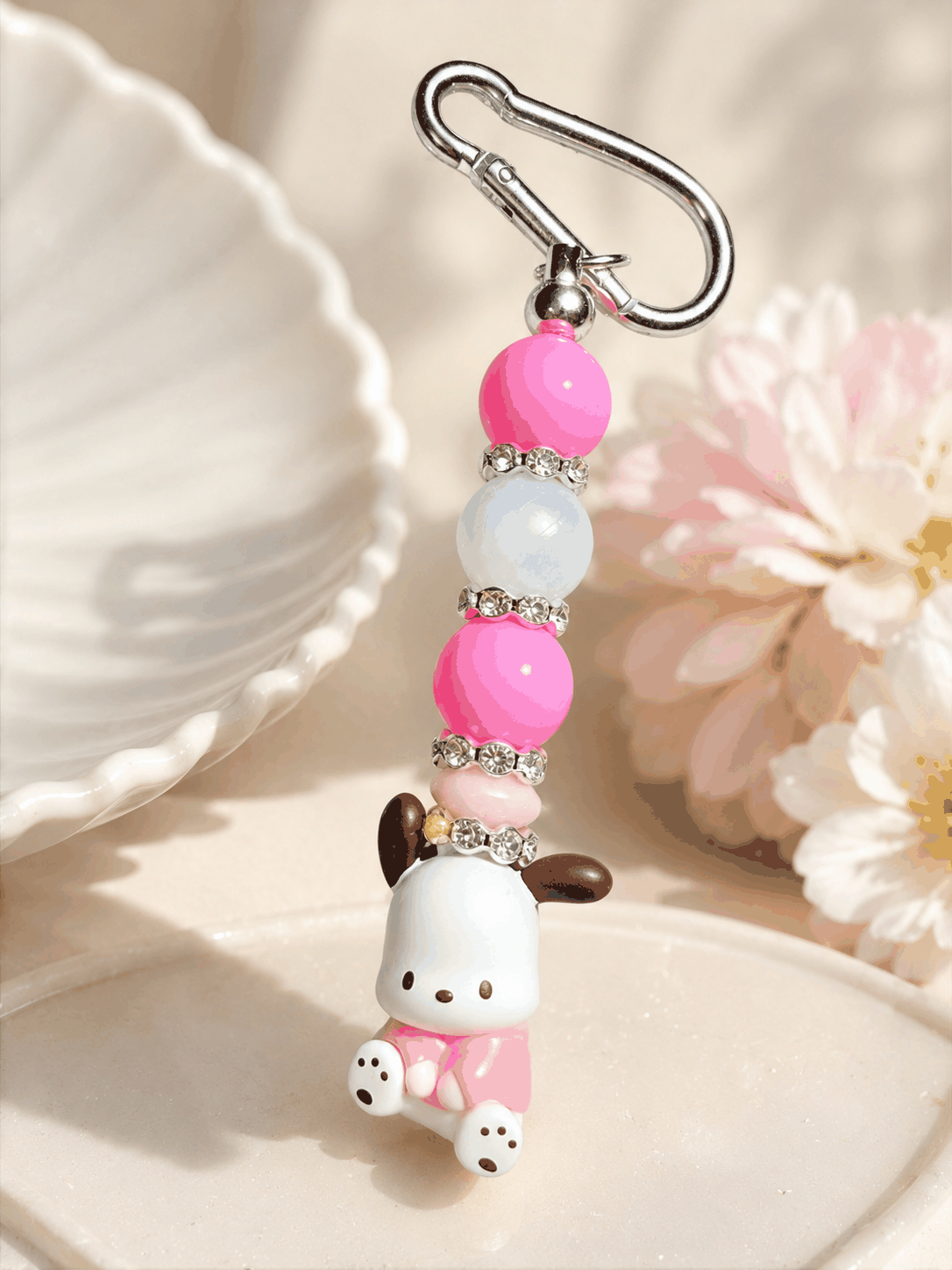 Keychain with a cute animal figure and colorful beads on a soft background