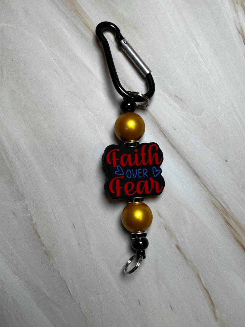 Red, Blue, Black, and Gold Faith Over Fear Keychain with Black Carabiner Clip